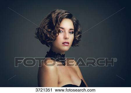 Portrait of a young woman, looking toward the lens View Large Photo Image Stock Image - Portrait of a young woman, looking toward the lens. Fotosearch