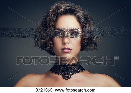 Portrait of a young woman, looking towards the lens, a lace blindfold View Large Photo Image Stock Image - Portrait of a young woman, looking towards the lens, a lace blindfold. Fotosearch