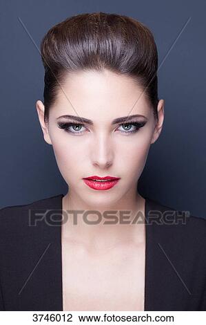 Portrait of a young woman, looking toward the lens View Large Photo Image Stock Image - Portrait of a young woman, looking toward the lens. Fotosearch