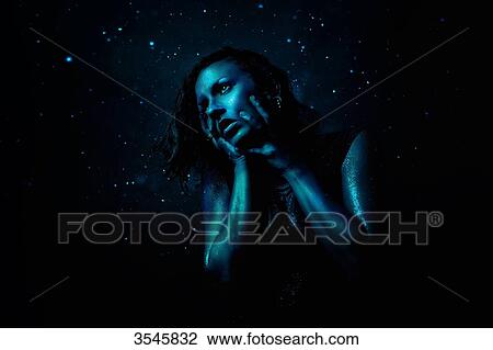 Portrait of a young woman painted in blue holding his head with her hands View Large Photo Image Stock Image - Portrait of a young woman painted in blue holding his head with her hands. Fotosearch