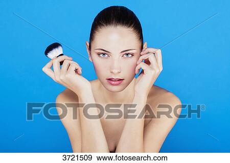 Stock Photo - Portrait of a young woman with a kabuki, looking toward the lens. Fotosearch
