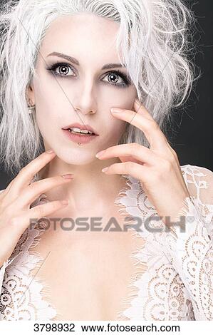 Portrait of a young woman with white hair, hands close to face, looking up View Large Photo Image Stock Image - Portrait of a young woman with white hair, hands close to face, looking up. Fotosearch