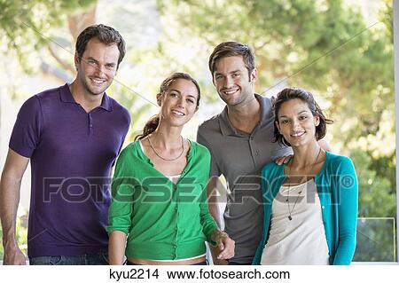 Picture - Portrait of four friends smiling. Fotosearch