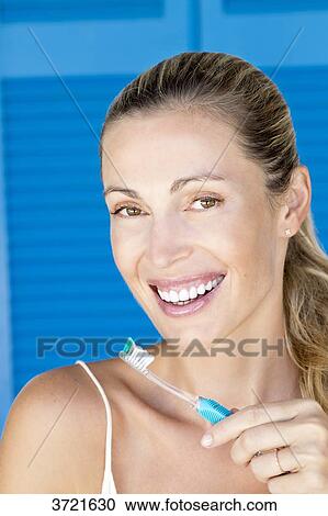 Portrait of smiling blond woman with toothbrush View Large Photo Image Stock Image - Portrait of smiling blond woman with toothbrush. Fotosearch