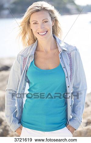 Portrait of smiling woman with denim shirt View Large Photo Image Stock Photo - Portrait of smiling woman with denim shirt. Fotosearch