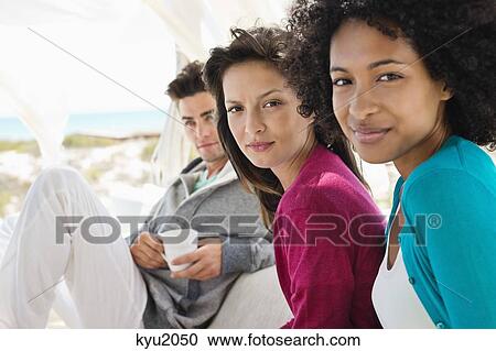 Stock Image - Portrait of two female friends smiling. Fotosearch