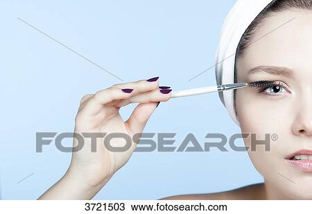 Portrait young blond woman making up eyelashes View Large Photo Image Stock Image - Portrait young blond woman making up eyelashes. Fotosearch