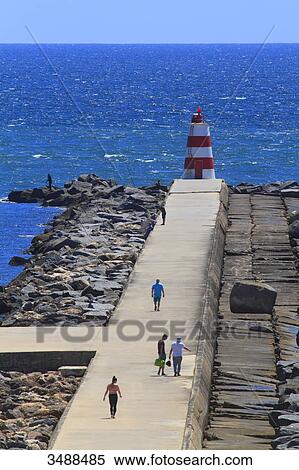 Stock Photography - Portugal, Algarve, Portimao. People walking on the embankment.. Fotosearch