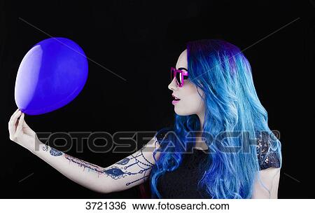 Profile of a pretty girl with blue hair holding a balloon View Large Photo Image Stock Photograph - Profile of a pretty girl with blue hair holding a balloon. Fotosearch