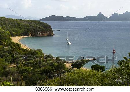 Stock Photograph - Sailing boat at the mooring, Saline Bay's beach, Mayreau, Saint-Vincent and the Grenadines, West Indies. Fotosearch
