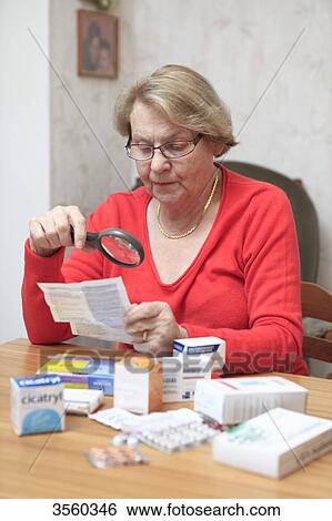 Senior woman reading medecine instructions. View Large Photo Image Stock Photograph - Senior woman reading medecine instructions.. Fotosearch