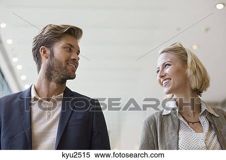 Smiling couple looking at each other View Large Photo Image Stock Photography - Smiling couple looking at each other. Fotosearch