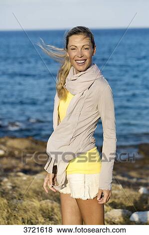 Smiling woman at seaside View Large Photo Image Stock Photo - Smiling woman at seaside. Fotosearch