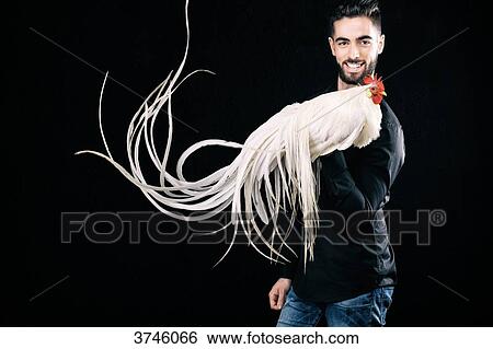 Smiling young farmer, holding his cock Onagadori Hakuro in his hand View Large Photo Image Stock Photograph - Smiling young farmer, holding his cock Onagadori Hakuro in his hand. Fotosearch