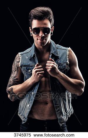 Smiling young man holds his jean jacket View Large Photo Image Stock Photography - Smiling young man holds his jean jacket. Fotosearch