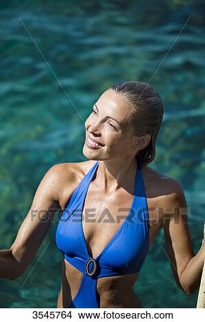 Smiling young woman going to swim View Large Photo Image Picture - Smiling young woman going to swim. Fotosearch