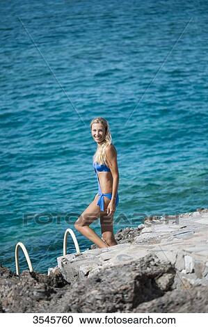 Smiling young woman going to swim View Large Photo Image Stock Image - Smiling young woman going to swim. Fotosearch