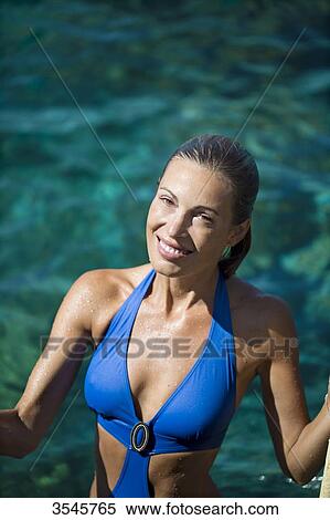 Smiling young woman going to swim View Large Photo Image Stock Photography - Smiling young woman going to swim. Fotosearch