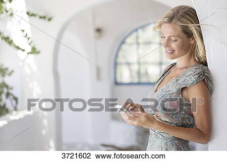 Smilling woman writing on his phone View Large Photo Image Stock Image - Smilling woman writing on his phone. Fotosearch