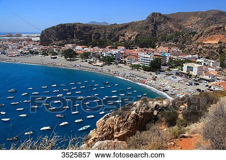 Stock Photo - Spain, Andalusia, Costa del Sol, lined up boats in Calahonda Bay.. Fotosearch