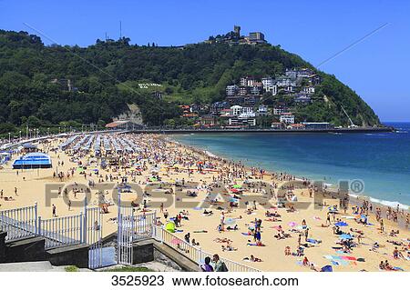 Spain, Basque Country. San Sebastian. Vacationers on the beach in summer. La Concha Bay. View Large Photo Image Stock Image - Spain, Basque Country. San Sebastian. Vacationers on the beach in summer. La Concha Bay.. Fotosearch