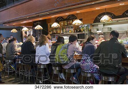 Spain, Catalonia, Barcelona, Boqueria Market, clients at the bar of a restaurant View Large Photo Image Stock Photograph - Spain, Catalonia, Barcelona, Boqueria Market, clients at the bar of a restaurant. Fotosearch