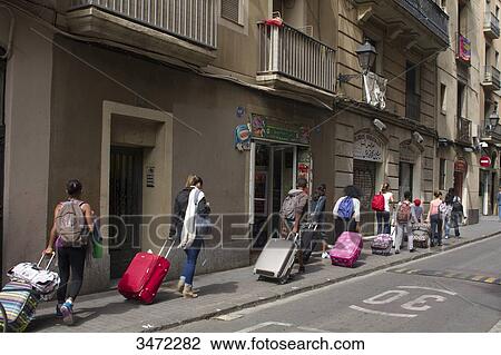 Spain, Catalonia, Barcelona, Carrer de l'Hospital, a group of pupils walking in line with roller suitcases View Large Photo Image Stock Image - Spain, Catalonia, Barcelona, Carrer de l'Hospital, a group of pupils walking in line with roller suitcases. Fotosearch