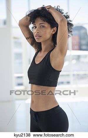 Stock Photo - Sportswoman standing with her hands on head. Fotosearch