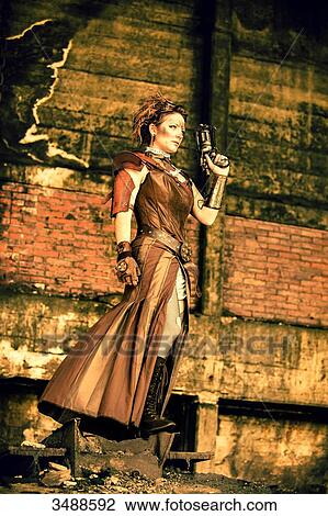 Stock Image - Steampunk woman watching the horizon. Fotosearch