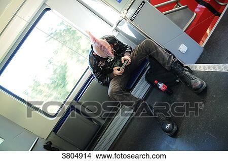 Switzerland, punk with pink hair staring at his smartphone in the train between Geneva and Lausanne View Large Photo Image Picture - Switzerland, punk with pink hair staring at his smartphone in the train between Geneva and Lausanne. Fotosearch