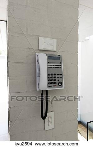Telephone mounted on a wall View Large Photo Image Picture - Telephone mounted on a wall. Fotosearch