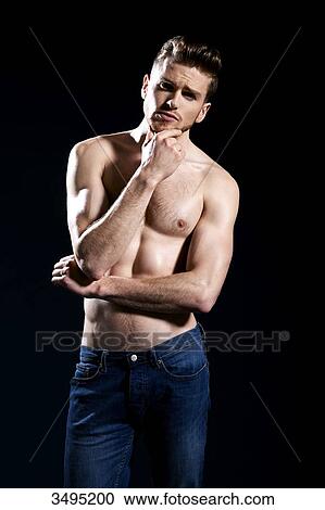 Topless man, black background; one hand on his chin, wearing jeans, serious, thinking, forehead creased. View Large Photo Image Stock Image - Topless man, black background; one hand on his chin, wearing jeans, serious, thinking, forehead creased.. Fotosearch