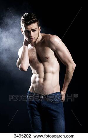Topless man, black background; wearing jeans, serious, one hand behind his neck, one hand in his back pocket, frowning, smoke behind. View Large Photo Image Stock Image - Topless man, black background; wearing jeans, serious, one hand behind his neck, one hand in his back pocket, frowning, smoke behind.. Fotosearch