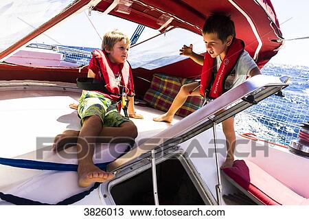 Two boys 5 and 7 years old are playing on a ship, Saint-Pierre, Martinique, France View Large Photo Image Stock Image - Two boys 5 and 7 years old are playing on a ship, Saint-Pierre, Martinique, France. Fotosearch