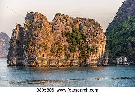 Stock Photograph - Vietnam, evening light on the Ha Long Bay, (UNESCO World Heritage). Fotosearch