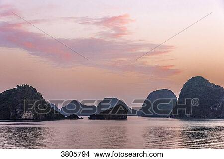 Vietnam, Ha Long Bay at sunset, (UNESCO World Heritage) View Large Photo Image Picture - Vietnam, Ha Long Bay at sunset, (UNESCO World Heritage). Fotosearch