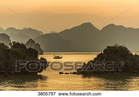Vietnam, Ha Long Bay at sunset, (UNESCO World Heritage) View Large Photo Image Stock Photo - Vietnam, Ha Long Bay at sunset, (UNESCO World Heritage). Fotosearch