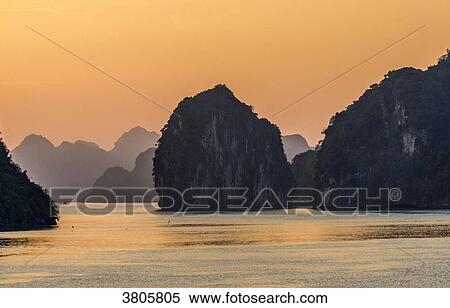 Vietnam, Ha Long Bay at sunset, (UNESCO World Heritage) View Large Photo Image Stock Photography - Vietnam, Ha Long Bay at sunset, (UNESCO World Heritage). Fotosearch