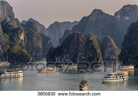 Vietnam, Ha Long Bay, cruise boat in the middle of islets (UNESCO World Heritage) View Large Photo Image Stock Image - Vietnam, Ha Long Bay, cruise boat in the middle of islets (UNESCO World Heritage). Fotosearch