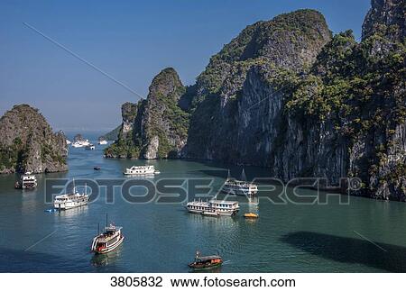 Vietnam, Ha Long Bay, cruise boat in the middle of islets (UNESCO World Heritage) View Large Photo Image Stock Image - Vietnam, Ha Long Bay, cruise boat in the middle of islets (UNESCO World Heritage). Fotosearch