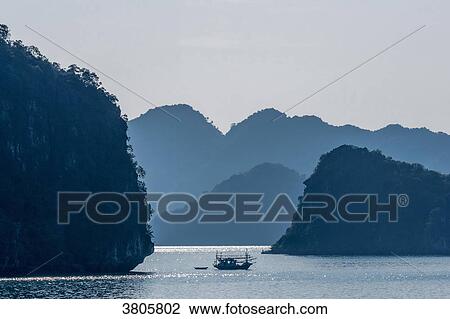 Vietnam, Ha Long Bay in the evening, fisher's small boat (UNESCO World Heritage) View Large Photo Image Stock Image - Vietnam, Ha Long Bay in the evening, fisher's small boat (UNESCO World Heritage). Fotosearch
