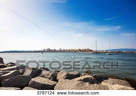 View of the city of Portimao from the jetty of the Praia da Rocha, region of Algarve, Portugal View Large Photo Image Picture - View of the city of Portimao from the jetty of the Praia da Rocha, region of Algarve, Portugal. Fotosearch