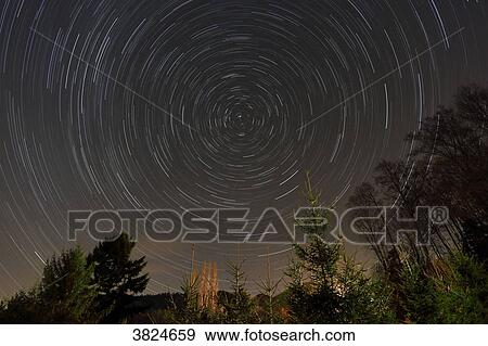 Stock Photo - Vosges. Altenbach. The celestial vault during its rotation in winter. Shooting star.. Fotosearch
