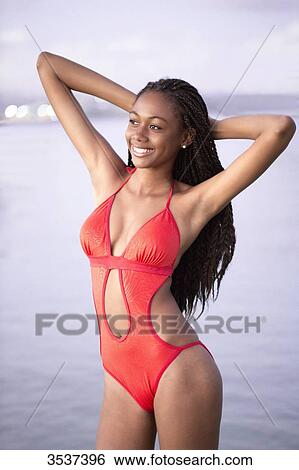 Stock Photograph - West indian smiling young girl in swimsuit. Fotosearch