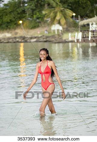 West indian young girl walking at seaside View Large Photo Image Stock Image - West indian young girl walking at seaside. Fotosearch
