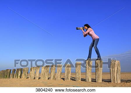 Woman at beach with professional camera View Large Photo Image Stock Image - Woman at beach with professional camera. Fotosearch