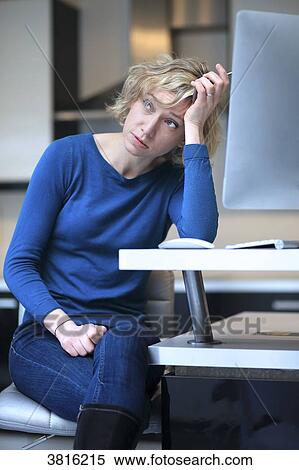 Stock Photography - Woman at home. Phone problems. Fotosearch