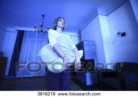 Woman at home, stand up at night View Large Photo Image Stock Photo - Woman at home, stand up at night. Fotosearch