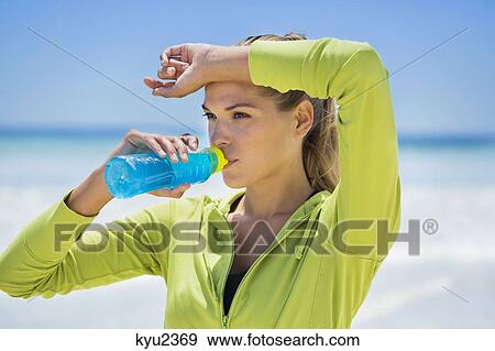 Stock Photo - Woman drinking water from a bottle. Fotosearch