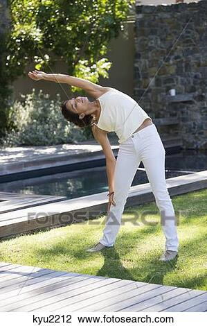Woman exercising in a lawn View Large Photo Image Stock Image - Woman exercising in a lawn. Fotosearch